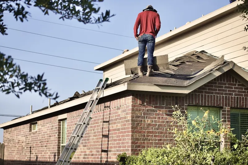 Professional roofer working on a residential roof in Bowie Mill Park